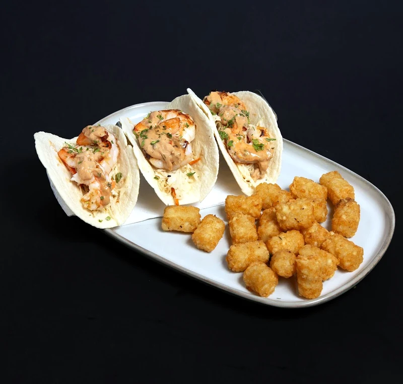 Shrimp tacos with tater tots at Rise & Dine Restaurant